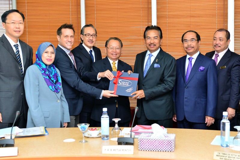 Scuba Zoo presenting a book to Chief Minister of Sabah